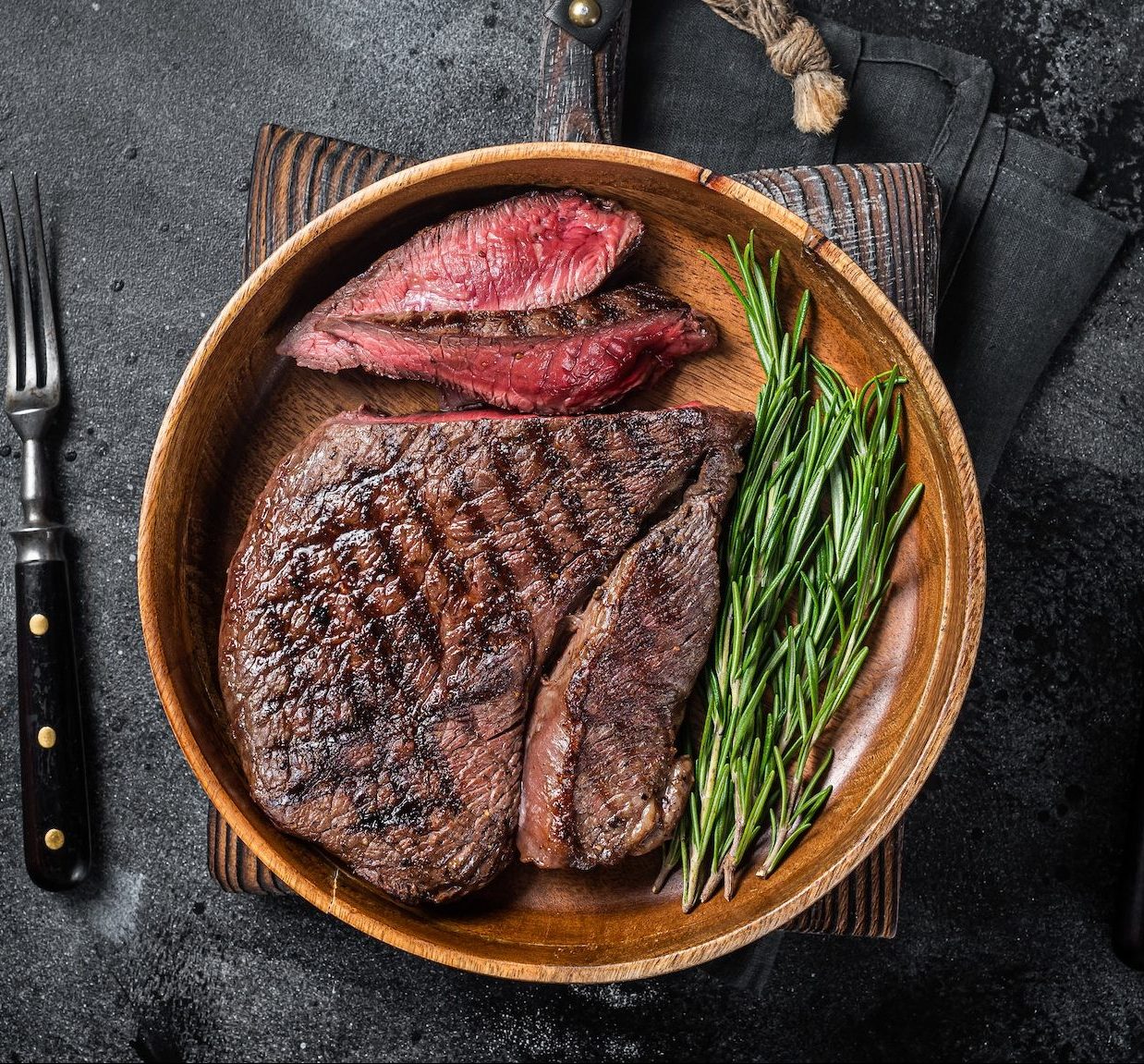 bbq-grilled-medium-rare-top-sirloin-beef-steak-rump-steak-in-a-wooden-plate--e1664111691605.jpg